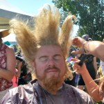 Jerami Youngblood of Homer gets his hair teased by Allyson Novy of Anchorage as part of the festival fun.-Photo by Rashah McChesney, Morris News Service - Alaska