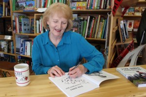 Author Dorothy “Dottie” Cline signs copies of “Paul Banks, Alaskan Music Man” at the Homer Bookstore on Sept. 27.-Photo by  McKibben Jackinsky, Homer News