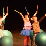 Addison Szocinski and Finnegan Mattingly were part of a group playing percussion with sticks on exercise balls.