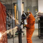 Eulita Basargin puts a smooth finish on a project created during the After-School Welding Academy.