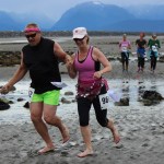 Deland Anderson, left, and Christine Anderson, second to left, make the five-mile course a hand-holding, barefoot,  joint effort. They are followed closely by Judith Steyer, Saundra Hudson and Maureen Filipek. -Photo by McKibben Jackinsky, Homer News