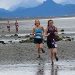 Rachel Seneff, right, and Terri Mach, second to right, lead a group of runners in the fourth of five miles during Sunday’s Breast Cancer Run on Mariner Beach.-Photo by McKibben Jackinsky, Homer News