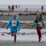Channing Lowney, 7, and Nuala Stenson, 6, dash to fourth and fifth place, respectively in the one-mile course.-Photo by McKibben Jackinsky, Homer News