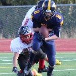 Teddy Croft, 8, scores a touchdown for the Homer Mariners in Saturday’s game against the Houston Hawks.-Photo by McKibben Jackinsky, Homer News