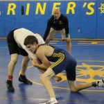 Mariner Jared Brant, who placed fifth at state last year, wrestles his Nikiski opponent during scrimmages in the Mariner mat room on Saturday. Mariner Coach Chris Perk referees.-Photo by McKibben Jackinsky, Homer News