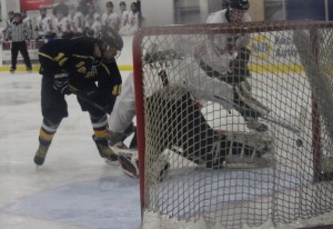 Mariner forward Owen Delehanty, left, battles for the puck during the Regions Feb. 6 game against Kenai.-Photo by McKibben Jackinsky, Homer News