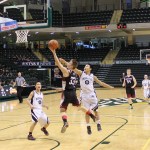 Nikolaevsk's Felemon Molodih, 33, outreaches his Manokotak opponent in a shot for two points during the game for fourth-place at the ASAA 1A State Basketball Tournament in Anchorage last week. Teammate Anfim Kalugin, 54, moves in to assist. -Photo by McKibben Jackinsky, Homer News