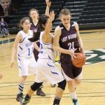 Nikolaevsk's Serafima Kalugin works around the Newhalen defense in the battle for fourth-place in the 1A State basketball tournament.-Photo by McKibben Jackinsky, Homer News