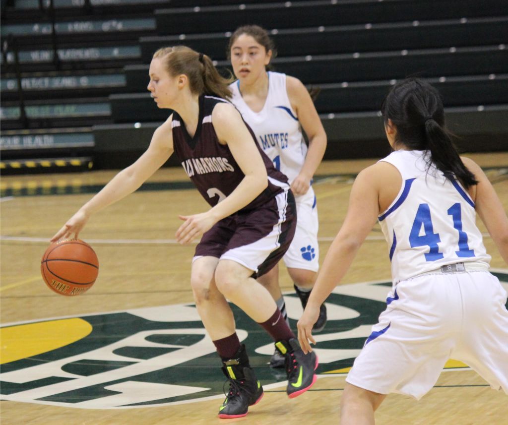 Nikolaevsk senior Kilina Klaich stays a step ahead of the Newhalen Malamutes at the 1A State basketball tournament game for fourth place.-Photo by McKibben Jackinsky, Homer News