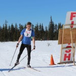Anchorage skier Lex Treinen is the first to cross the finish line.-Photo by McKibben Jackinsky, Homer News