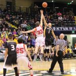 Seldovia's Aidan Philpot, 33, gives the Otters the tip off in the 1A State championship game against the Scammon Bay Eagles. Teammate Chance Haller, 25, waits for the action to begin.-Photo by McKibben Jackinsky, Homer News