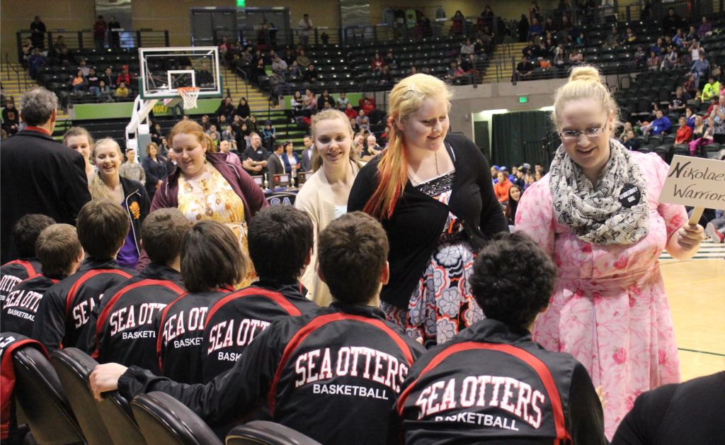 In the ASAA 1A State Basketball Tournament's parade of athletes, the fourth-place Nikolaevsk girls team congratulates the first-place Seldovia boys team. Nikolaevsk players from left: Vera Fefelov, Anastacia Dorvall, Kilina Klaich, Nadejda Gordeev, Ellena Gordeev.-Photo by McKibben Jackinsky, Homer News