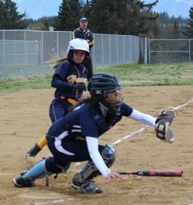 Mariner Riley Wall is blocked from home plate by the SoHi Stars’ catcher during the May 7 game in Homer.-McKibben Jackinsky