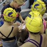 Jan Rumble helps first-time competitors keep track of their events.-Photo by McKibben Jackinsky, Homer News