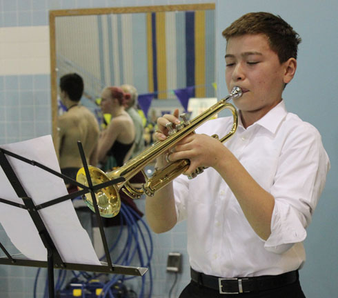KSC swimmer Ethan Benedetti begins Saturday’s competition by playing The  Star Spangled Banner.-Photo by McKibben Jackinsky, Homer News