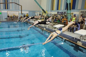 Swimmers dive into the action during the Kachemak Swim Club’s last home meet of the season Saturday at the Kate Kuhns Aquatic Center. The meet drew 220 competitors.