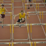 Senior Mark McGregor jumps hurdles in the Big C Relays last week.