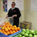 Lt. Christin Frankhauser of the Salvation Army bags fresh vegetables and fruits to be added to the Thanksgiving baskets.