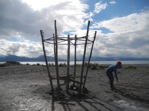 Hannah Apricot works on “Enjoy,” the 2013 Homer Burning Basket, on Tuesday at Mariner Park. The basket is burned at sundown on Sunday.  -Photo by Michael Armstrong, Homer News
