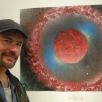 Jesse Smith, Moonkloud, stands next to his painting, “The Fire Within,” at the Emerging Artists show on First Friday for the Homer Council on the Arts.-Photo by Michael Armstrong, Homer News