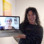 Asia Freeman holds up a laptop computer showing her mother, Karla Freeman, attending by Skype the opening of Karla Freeman’s show earlier this month at Bunnell Street Arts Center.             -Photo by Michael Armstrong, Homer News
