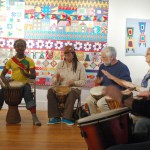 Soriba Fofana, left, demonstrates a drumming pattern on his djembe at a workshop Monday night at Bunnell.-Photo by Michael Armstrong, Homer News