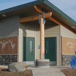 Homer artist Joshua Nordstrom’s art is on the bathroom at WKFL Park on Pioneer Avenue. A Homer Cycling Club bike rack also is shown.-Photo by Michael Armstrong, Homer News