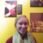 Libby Fabich stands by her photograph, “A Team Can Go Far if They Work Together,” at the First Friday opening of the PhotoVoice exhibit at K-Bay Caffe.                                           -Photo by Michael Armstrong, Homer News