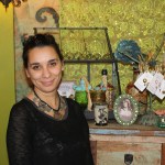 Bekah Dalke pauses for a picture in front of a display that shows a bit of the diversity featured in her new shop, Oodalolly.-Photo by Lindsay Olsen