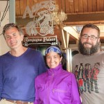 Todd and Beth Boling, left and center, and Matt North, right, pose in front of the Alice's Champagne Palace mirror on Monday. The Bolings and North have purchased the iconic Homer bar from the English Bay Corporation.-Photo by Michael Armstrong, Homer News