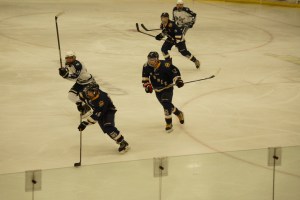 Mariner Tim Blakely skates the puck past SoHi to try to get a shot on goal; Dimitry Kuzmin and Dawson Roberts provide support.-photo by Tracey Tillion