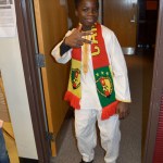 Cameroonian exchange student Nouredine Mama poses in traditional dress during a presentation about his country for students at Nikolaevsk School on Nov. 25.-photo by Annie Rosenthal
