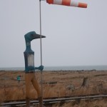The windsock on Rachelle Dowdy’s loon sculpture is almost straight out in high winds at Bishop’s Beach on Monday afternoon.-photo by Michael Armstrong
