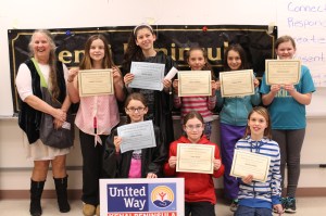 Youth Court members — Natalie Harrington, Delilah Harris, Alana Houlihan, Sabina Morin, Abrianna Smith, Lillian Sweeney, Irais Turner and Beatrix Strobel — pose with Kenai Peninsula Youth Court Executive Director Ginny Espenshade after she swore them in at the Thursday, Jan. 14 ceremony.-Photo by Anna Frost, Homer News