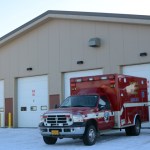 Elizabeth and Emily Boyle pose in front of a fire truck.-Photo at Michael Armstrong, Homer News