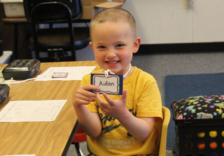 Student Jack Faber, right, says good-bye to his sister Emilly and dad Jack on his first day of kindergarten at Paul Banks Elementary School.