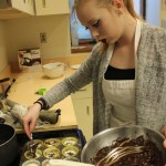 Hanna Marsh,  puts a chocolate drizzle on dessert.-Photo by McKibben Jackinsky, Homer News