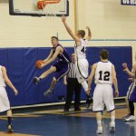 Hunter Harris, 42, blocks a Panther’s attempt at a basket, with Kenneth Schneider, 12, ready to assist.  -Photo by McKibben Jackinsky, Homer News
