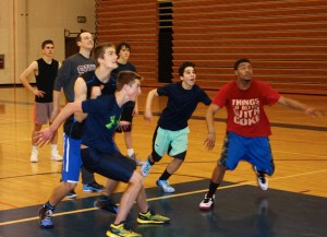 Brandon Beachy, front left, boxes out Sheldon Hutt, while Kenzington Cortez and Jaruby Nelson await the ball during practice. In the background, Kenneth Schneider, Head Coach Nate Creel and Kannen Cabana look on.-Photo by Lindsay Olsen