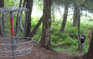 Russell Crocker throws to the first basket of the Jack Gist Park disc golf course on Friday.-Photo by Shannon Reid