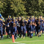 The Mariners take to the field on Saturday, led by seniors Shelton Hutt, 7; Connor Seay, 24; Ian Lowe, 13; Eric Hill, 18; Isaia Kuzman, 72; and Ulian Kuzman, 67.-Photo by McKibben Jackinsky, Homer News