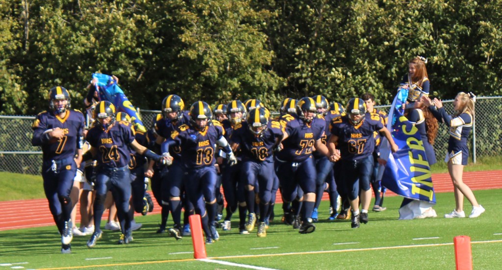 The Mariners take to the field on Saturday, led by seniors Shelton Hutt, 7; Connor Seay, 24; Ian Lowe, 13; Eric Hill, 18; Isaia Kuzman, 72; and Ulian Kuzman, 67.-Photo by McKibben Jackinsky, Homer News