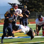 Mariner Josh Fisk, 32, attempts to sidestep a Houston tackle.-Photo by McKibben Jackinsky, Homer News