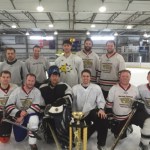 The winner of the Ash Cup, Prestige World Wide of Anchorage, poses with the trophy Sunday. Prestige World Wide won the tourney after a 3-1 win over the Wolves.