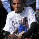 Amelia Boynton-Robinson, known affectionately as Miss Boynton and the queen mother of the civil rights movement, is escorted across the bridge.-Photo by Katie Gavenus