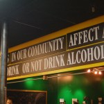 A sign at the PhotoVoice exhibit poses the question artists were asked to explore: “What factors in our community affect a teen’s decision to drink or not drink alcohol?”        -Photo by Michael Armstrong, Homer News
