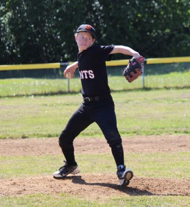 Mose Hayes winds up a pitch during Saturday’s game against a Kenai team.-Photo by McKibben Jackinsky