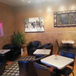 Guests to the Fat Olives coffee shop find a warm, intimate space. Marigold-colored walls keep the space bright and sunny. Plus, there’s a view of Kachemak Bay.-Photo by Katir Britton, Homer News