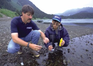 Mark Kinney and Brandon Moonin sample water quality at Port Graham.-Photo provided