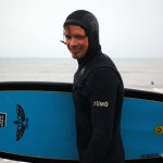 Homer photographer Scott Dickerson heads out surfing off the Homer Spit in the fall of 2012. Dickerson is part of a group of die-hard Homer surfers who catch waves even in midwinter.-Photo by Michael Armstrong, Homer News